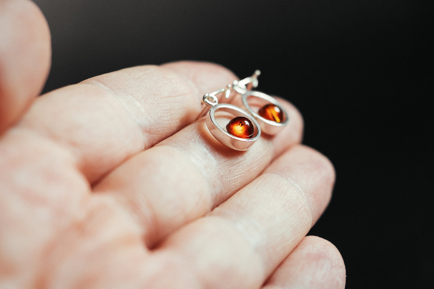Circular Radiance - Silver Circle Dangle Earrings with Captivating Baltic Amber