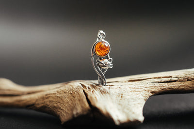 Silver cat charm with natural amber.
