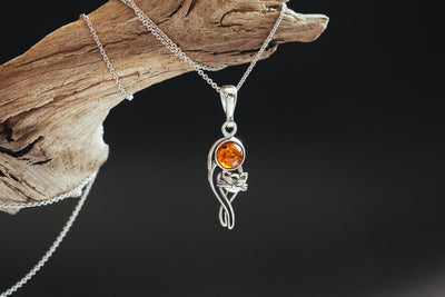 Silver cat charm with natural amber.