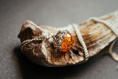 Round, filigree, pendant with Baltic amber.